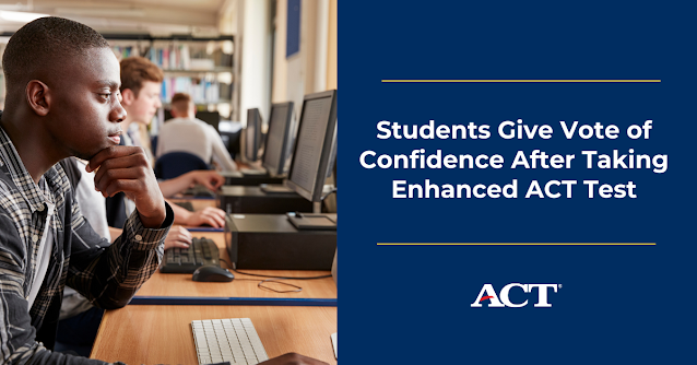 Students sit at a row of computers, engaged by their screes. One student, in the foreground of the photograph thinks intently with his hand by his mouth.