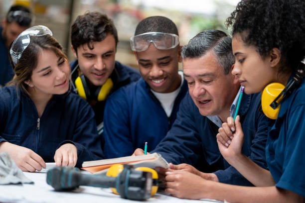 students training and working in a manufacturing plant