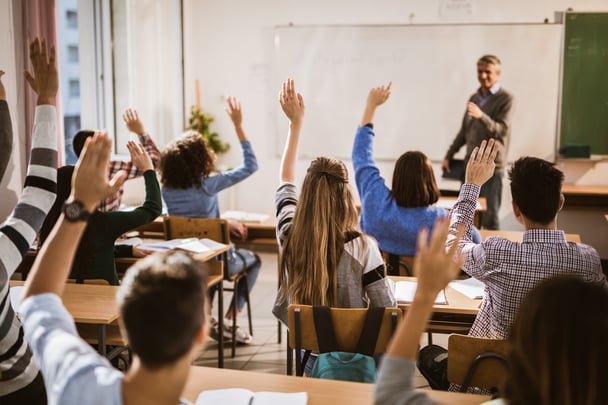 back of heads hands raised 1-GettyImages-1077184960